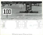 1983 Press Photo Employee At Golf Driving Range Drives Picker Retrieve Balls. Fixed Price $24.99.